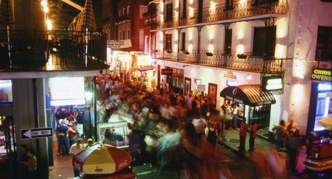 Crowded street at night in the French Quarter of New Orleans, LA.