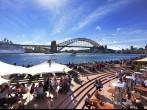 SYDNEY AUSTRALIA - SEPTEMBER 15, 2013: Residents and visitors dine, relax and basque in the glorious afternoon sun quayside by the harbour, Sydney Australia.  ;