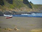 Colourful wooden fishing boat on the beach in the small coastal village of Cobquecura in Maule, Chile.