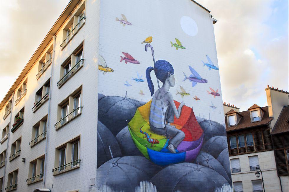 Street art in Paris / ne of Parisian buildings with beautiful painting on it, Paris, France.