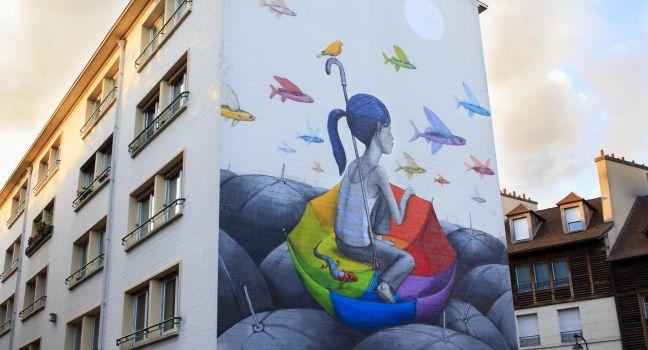 Street art in Paris / ne of Parisian buildings with beautiful painting on it, Paris, France.